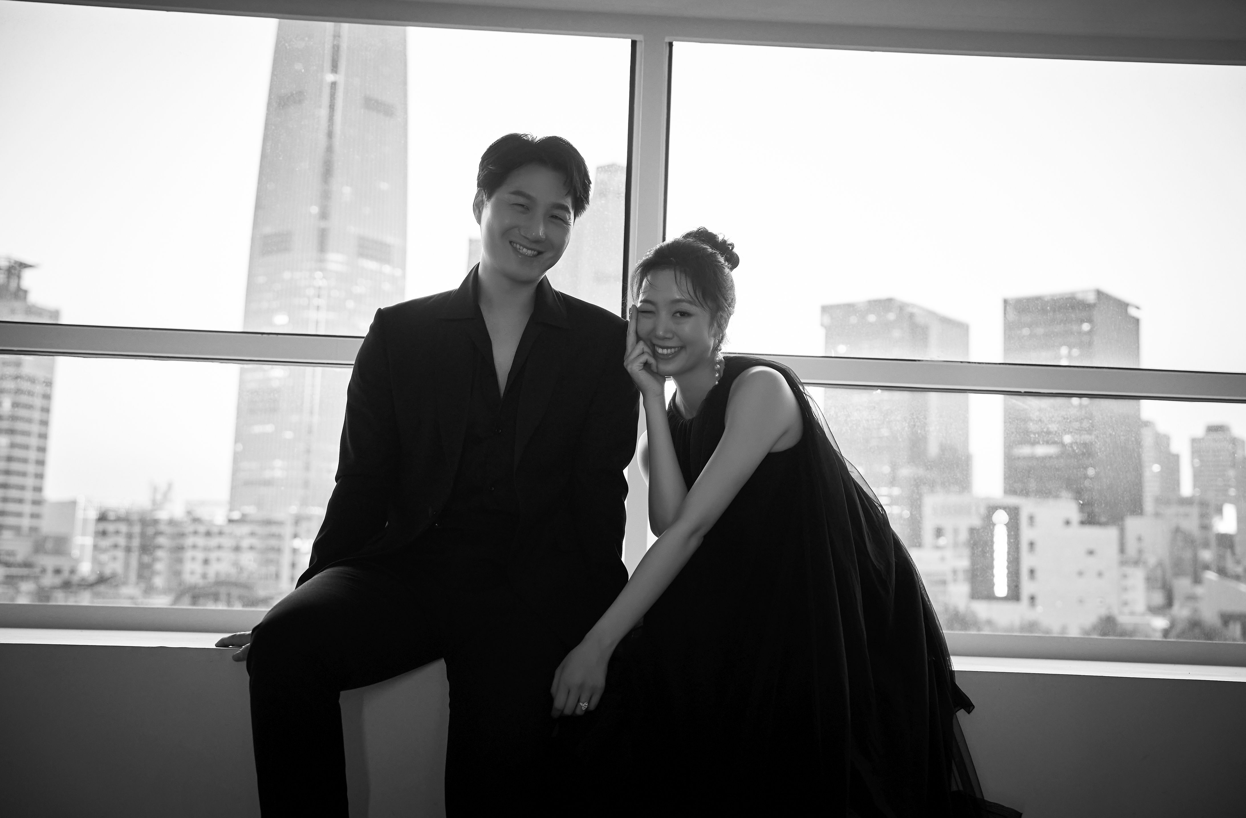 Joyce and Jason together in front of a city window